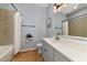 Modern bathroom with gray vanity, quartz countertop, and a shower/tub combo at 7746 108Th Avenue E Cir, Parrish, FL 34219