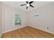 Light and airy bedroom featuring wood-look floors and a window with blinds at 7746 108Th Avenue E Cir, Parrish, FL 34219