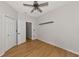 Bright bedroom with wood-look floors, ceiling fan, and double closets at 7746 108Th Avenue E Cir, Parrish, FL 34219