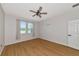 Bedroom with two windows, wood-look floors, and a ceiling fan at 7746 108Th Avenue E Cir, Parrish, FL 34219