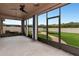 Spacious screened porch overlooking a grassy backyard with a firepit at 7746 108Th Avenue E Cir, Parrish, FL 34219