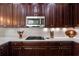 Spacious kitchen featuring gas cooktop and white subway tile backsplash at 10655 Glencorse Ter, Bradenton, FL 34211