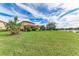 Spacious backyard with pond views and lush tropical plants at 10655 Glencorse Ter, Bradenton, FL 34211