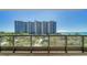 Balcony overlooking the ocean, pool, and building amenities at 1241 Gulf Of Mexico Dr # 303, Longboat Key, FL 34228