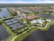 Aerial view of Esplanade, showcasing the community pool, tennis, and pickleball courts at 12413 Parigi Way, Sarasota, FL 34238