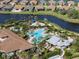 Aerial view of Esplanade's pool and clubhouse with surrounding homes at 12413 Parigi Way, Sarasota, FL 34238