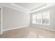 Spacious bedroom with large windows and wood-look tile floors at 12413 Parigi Way, Sarasota, FL 34238