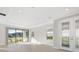 Bright and airy living room with sliding glass doors leading to backyard at 12413 Parigi Way, Sarasota, FL 34238