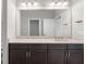 Modern bathroom vanity with granite countertop and large mirror at 12413 Parigi Way, Sarasota, FL 34238