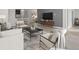 Open concept living room with modern furniture and a large TV at 12413 Parigi Way, Sarasota, FL 34238