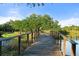 Charming wooden footbridge over a tranquil pond at 12413 Parigi Way, Sarasota, FL 34238
