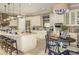 Elegant kitchen boasts an island, ample cabinetry, and breakfast nook at 12413 Parigi Way, Sarasota, FL 34238
