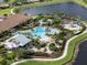 Aerial view of Esplanade's pool, clubhouse, and surrounding landscape at 12413 Parigi Way, Sarasota, FL 34238