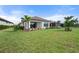 Spacious backyard with grassy lawn and home view at 12413 Parigi Way, Sarasota, FL 34238