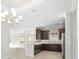Open concept kitchen with island, dark wood cabinets, and recessed lighting at 12413 Parigi Way, Sarasota, FL 34238