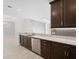 Modern kitchen with dark cabinetry and granite countertops at 12413 Parigi Way, Sarasota, FL 34238