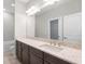 Bathroom vanity with granite countertop, sink, and large mirror at 12413 Parigi Way, Sarasota, FL 34238