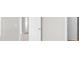 Hallway with white doors and light gray walls at 12413 Parigi Way, Sarasota, FL 34238