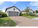 Two-car garage with gray doors and paver driveway at 12413 Parigi Way, Sarasota, FL 34238