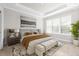 Main bedroom with king bed, neutral decor and large window at 12413 Parigi Way, Sarasota, FL 34238