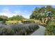 Peaceful walking path with scenic views and footbridge at 12413 Parigi Way, Sarasota, FL 34238