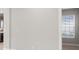 Empty hallway with light gray walls and wood floors at 12413 Parigi Way, Sarasota, FL 34238