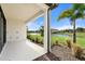 Covered patio overlooking a pond and landscaped area at 12413 Parigi Way, Sarasota, FL 34238