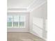 Bright bedroom with large window and neutral walls at 12413 Parigi Way, Sarasota, FL 34238