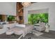 Tranquil spa-like room with massage table, plush chair, and large window at 12413 Parigi Way, Sarasota, FL 34238