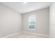 Spacious bedroom with large window and light gray walls at 12413 Parigi Way, Sarasota, FL 34238