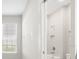 Clean bathroom with a shower/tub combo and a window at 12413 Parigi Way, Sarasota, FL 34238