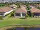 Aerial view of house and backyard near lake at 12413 Parigi Way, Sarasota, FL 34238
