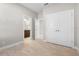 Bright bedroom with wood-look floors and double doors to closet at 12413 Parigi Way, Sarasota, FL 34238