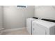 Laundry room with washer, dryer, and wire shelving at 12413 Parigi Way, Sarasota, FL 34238