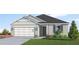 New construction home with gray siding and a two-car garage at 13020 Cedar Elm Lane, Parrish, FL 34219