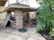 Outdoor kitchen with stone countertops and a covered patio at 1348 Harbor Dr, Sarasota, FL 34239