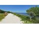 Peaceful walkway along the shore with benches and native vegetation at 1403 96Th Nw Ct, Bradenton, FL 34209