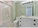 Contemporary bathroom with a white vanity, quartz countertop, and a glass shower/tub combo at 1637 Hyde Park St, Sarasota, FL 34239
