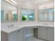 Bathroom featuring a double vanity and large mirrors at 1637 Hyde Park St, Sarasota, FL 34239