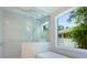 Spa-like bathroom with a walk-in shower and large window at 1637 Hyde Park St, Sarasota, FL 34239