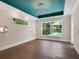 Bedroom with hardwood floors, unique ceiling, and pool view at 1637 Hyde Park St, Sarasota, FL 34239