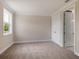 Well-lit bedroom with neutral walls, carpet, and a large window, featuring double doors to a closet at 1637 Hyde Park St, Sarasota, FL 34239