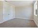 Bright bedroom with neutral walls and carpeting, featuring double doors and a large window at 1637 Hyde Park St, Sarasota, FL 34239