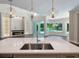 Modern kitchen island with a view of the pool and living room at 1637 Hyde Park St, Sarasota, FL 34239