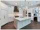 Modern kitchen with white cabinets, large island, and stainless steel appliances at 1637 Hyde Park St, Sarasota, FL 34239