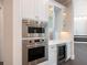 Built-in stainless steel oven and microwave, wine cooler, and white shaker cabinets at 1637 Hyde Park St, Sarasota, FL 34239