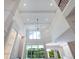 High ceiling living room with chandelier and large windows at 1637 Hyde Park St, Sarasota, FL 34239