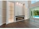 Modern built-in fireplace and glass shelving in living room at 1637 Hyde Park St, Sarasota, FL 34239