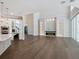 Open living room with a modern fireplace and glass shelving, hardwood floors, and access to the pool area at 1637 Hyde Park St, Sarasota, FL 34239