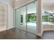 View of the pool and backyard through sliding glass doors at 1637 Hyde Park St, Sarasota, FL 34239